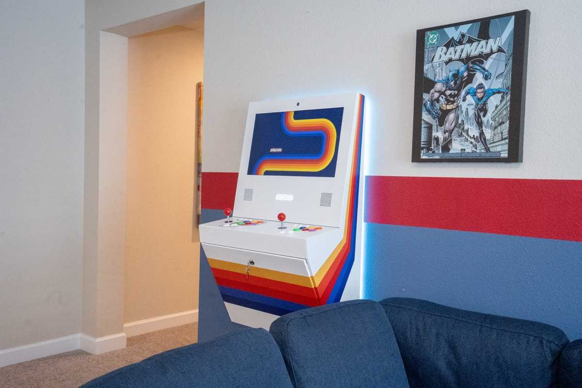 Polycade multicade arcade cabinet wall-mounted with LED backlighting in the game room at Parkside Retreat
