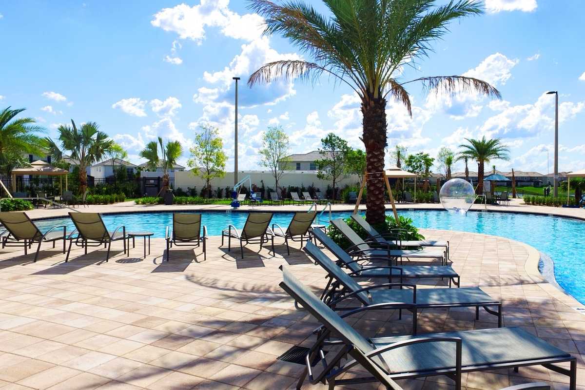 Sun loungers lined up beside the resort pool at Storey Lake Resort