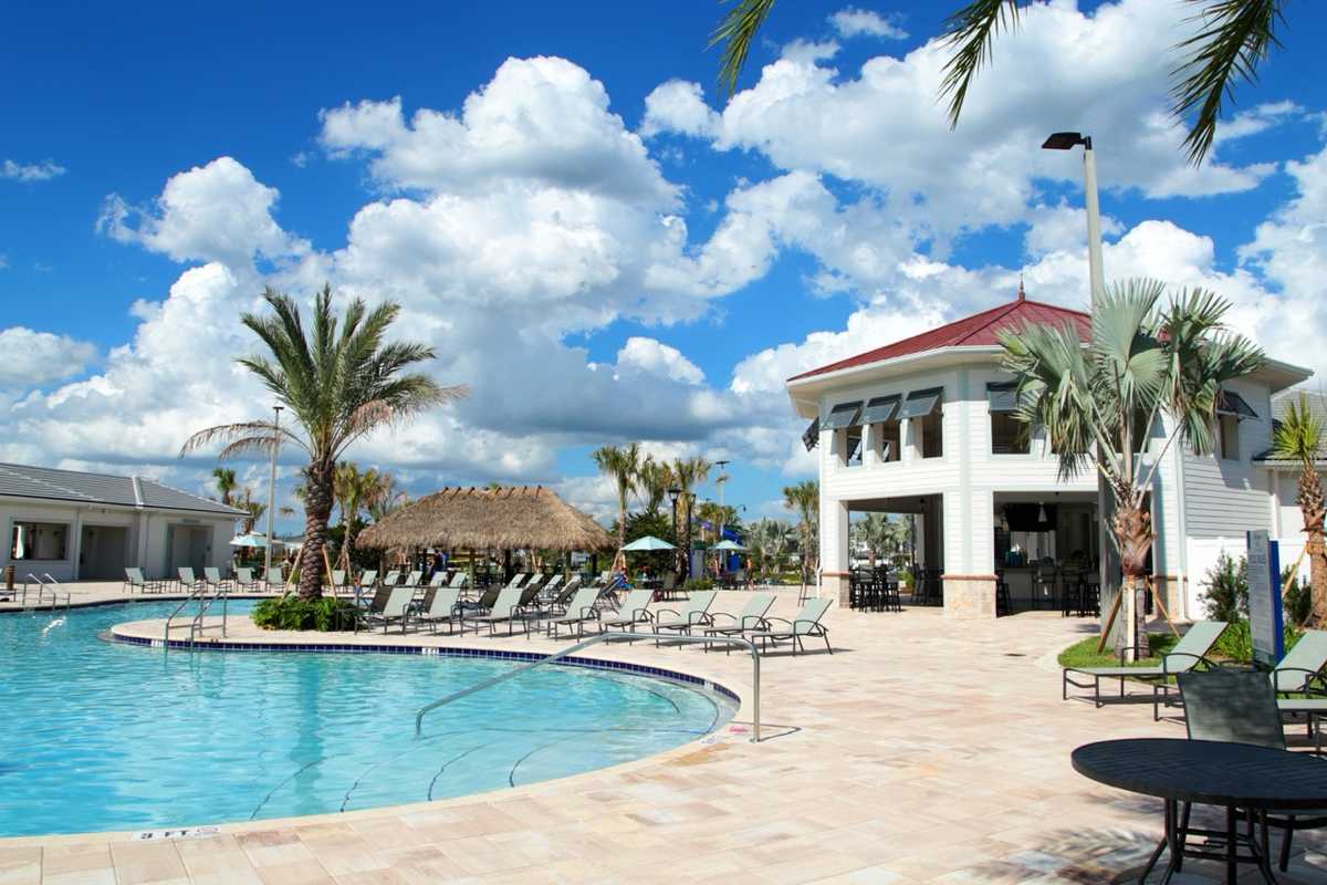 Resort-style swimming pool at the Storey Lake Hideaway Club with palm trees and loungers