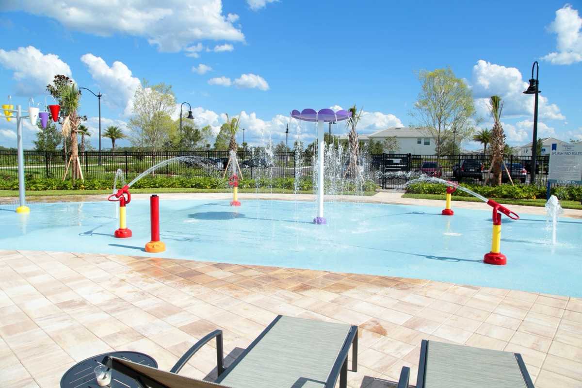 Kids enjoying the splash pad with fountains and spray jets at Storey Lake Resort