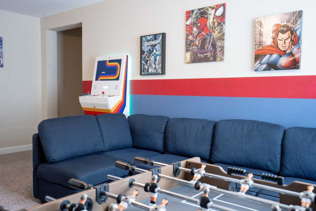 Game room at Parkside Retreat with Polycade arcade, foosball table, and superhero wall art
